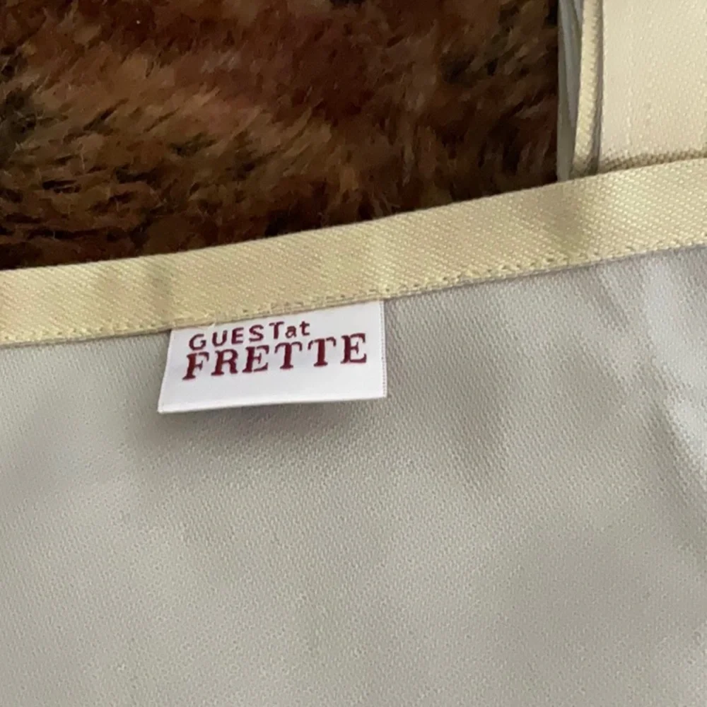 NEW FRETTE SET OF FOUR NAPKINS COLOR IS LIKE A FLAX WITH GREY/SILVER OTHER SIDE